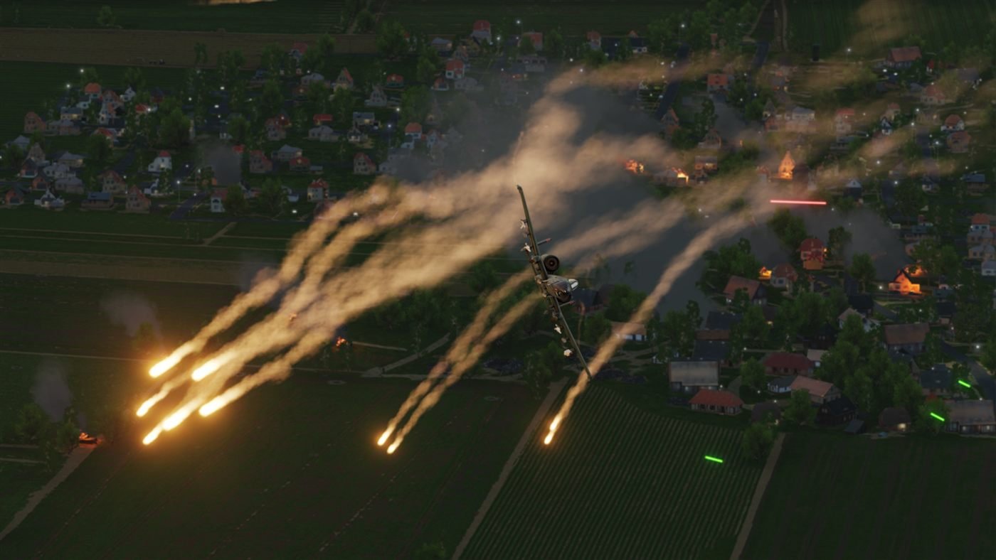 A-10 releasing flares above a town