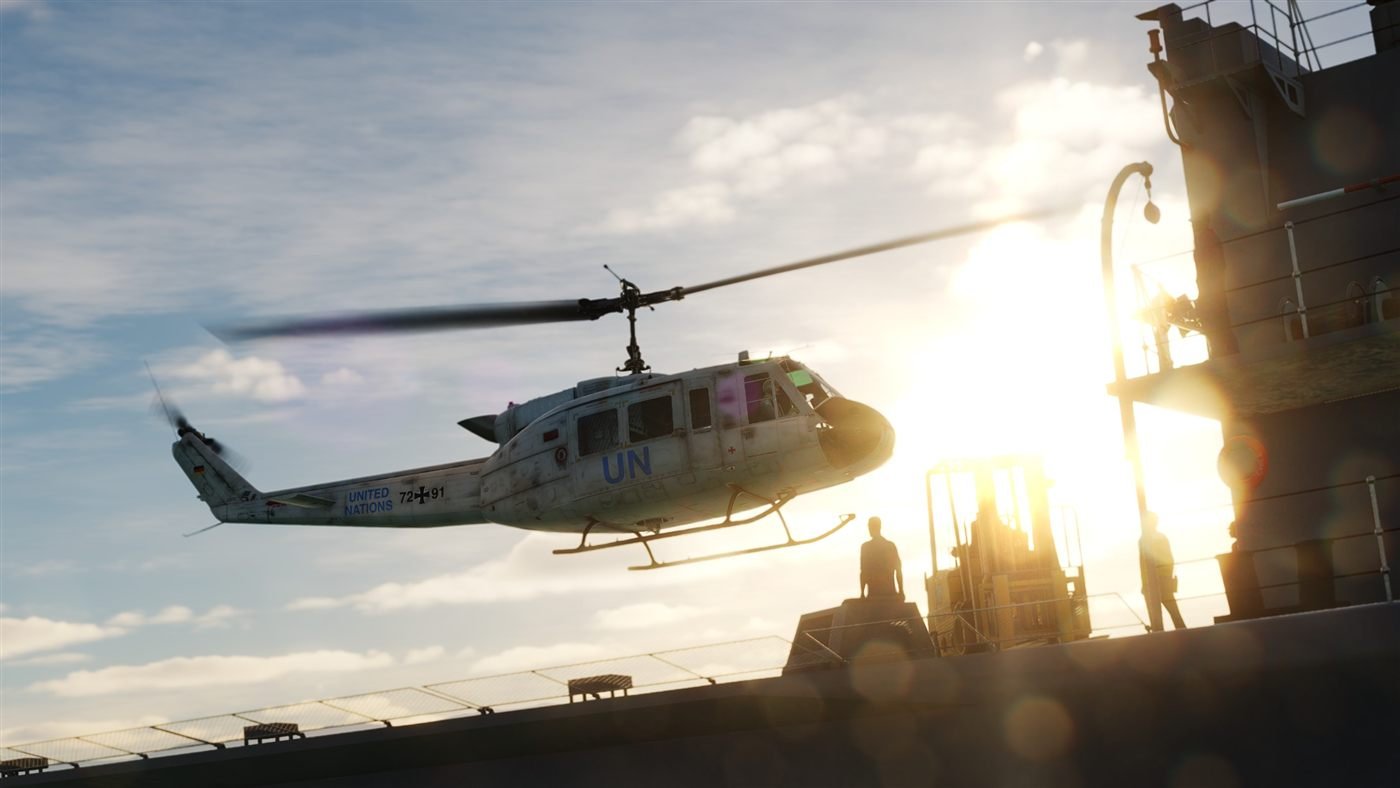 UH-1H approaching a ship at sunset